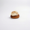 Cinnabon with cream cheese frosting on a white background
