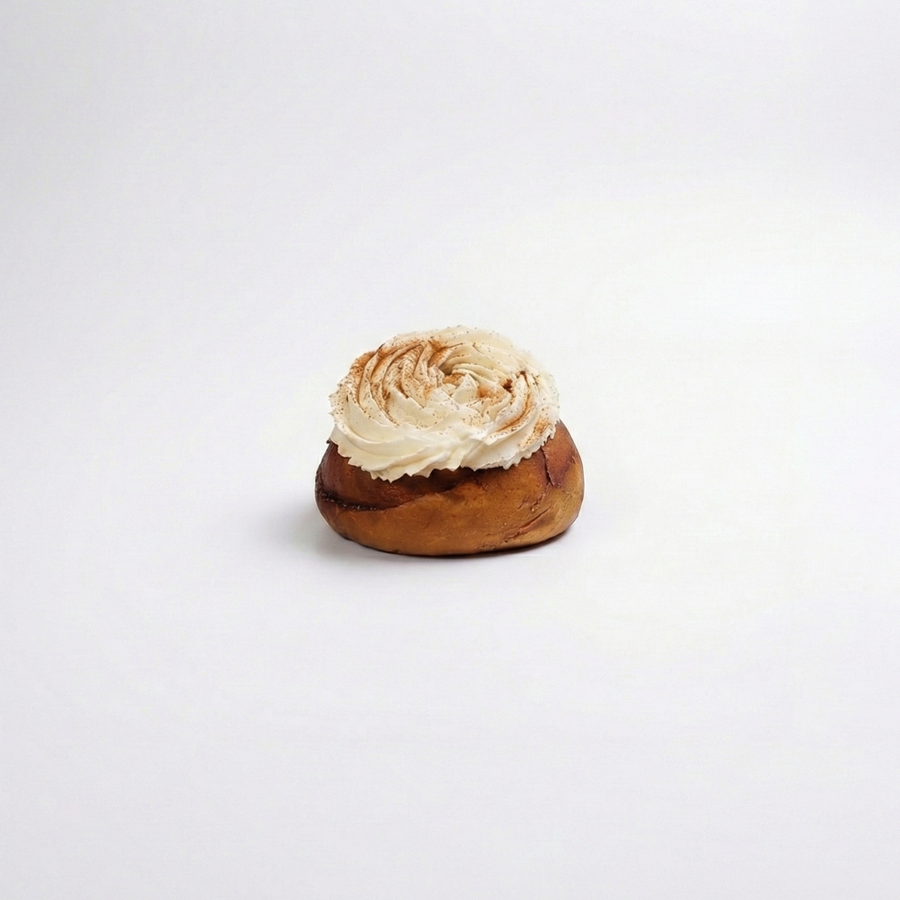 Cinnabon with cream cheese frosting on a white background