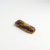 Eclair Chocolate-covered dessert with nuts on a white background
