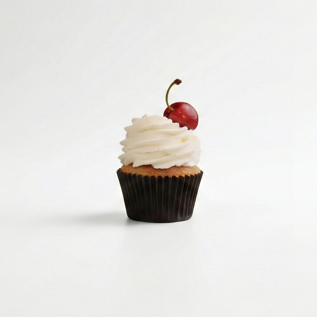 Cupcake with white frosting and a cherry on top against a white background in morristown nj