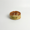 Small round dessert with a textured top and green crumbly topping on a light gray background in Morristown nj.