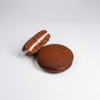 Whoopie Pie Chocolate macaron with white filling on a light gray background