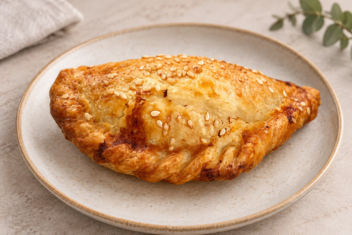 dän chicken samsa, a golden baked pastry topped with sesame seeds