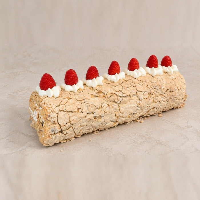dän pistachio roll — gluten-free meringue roll with mascarpone, crushed pistachios and fresh raspberries